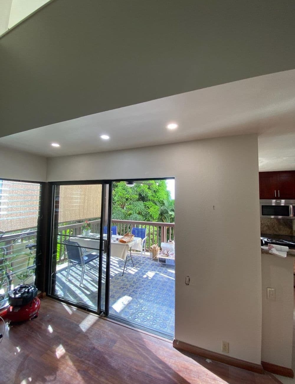 Bright living space with sliding doors, greenery outside, and modern decor details.